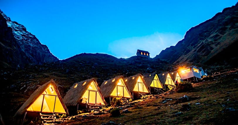 Salkantay Trek 5 days — mountain lodge cabins at dusk on Machu Picchu trail from Cusco
