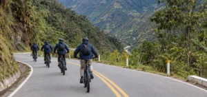 Inca Jungle Trek 4 days - mountain biker descending from Abra Málaga at 4,300 m (14,108 ft) toward the jungle